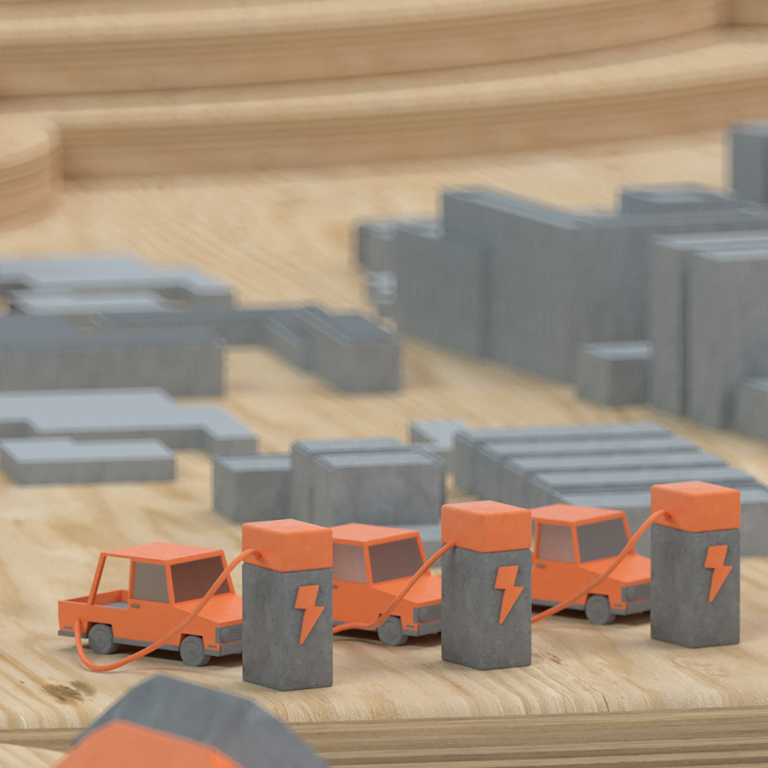 Tre bilar står och laddar